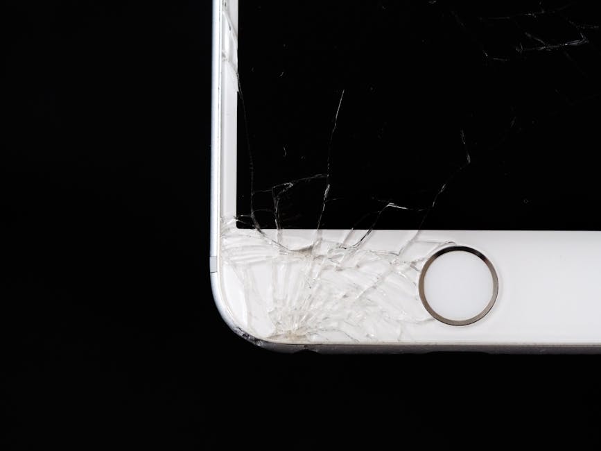 A smartphone with a deeply cracked screen, raising the question of whether it's worth repairing or replacing.
